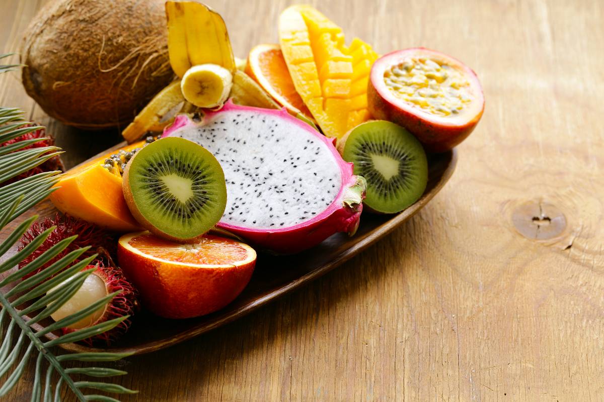 Fresh tropical fruits are waiting to be gathered A collection of tropical fruits are cut and being served